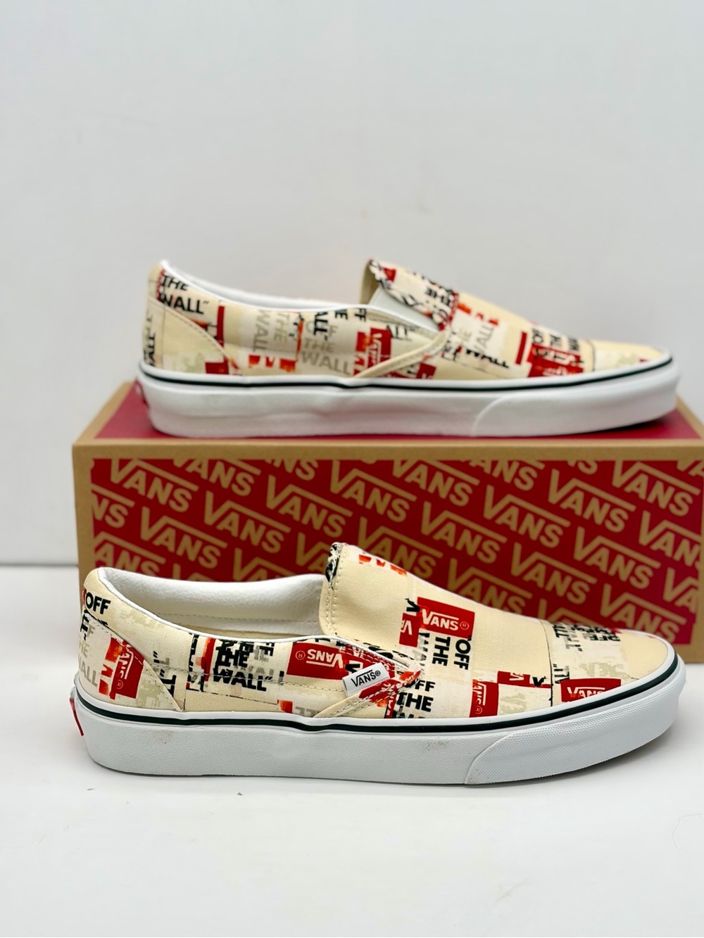 Vans classic Slip-On Sneakers in Cream & Red Logo Print